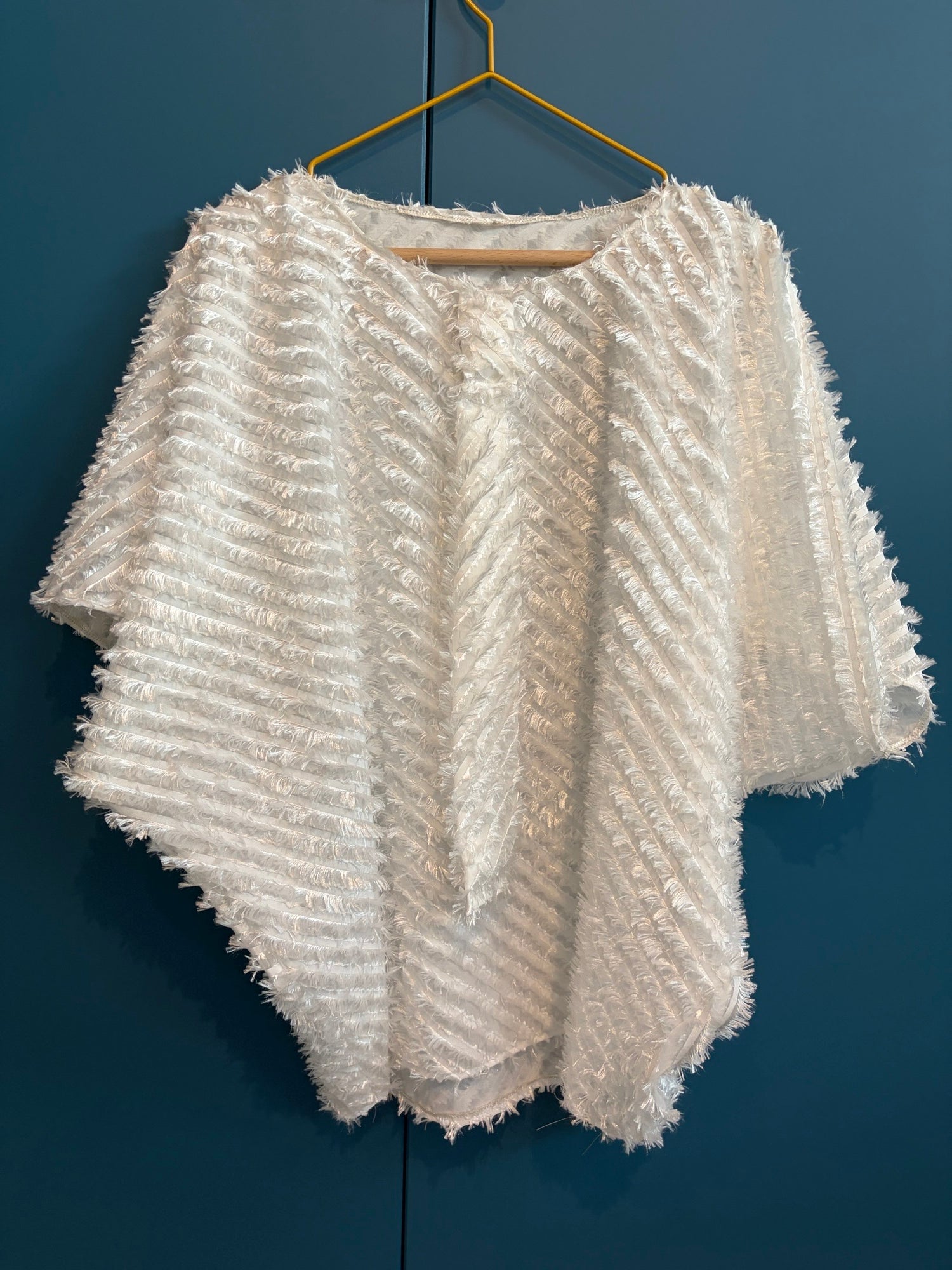 Light weighted feathery off-white top