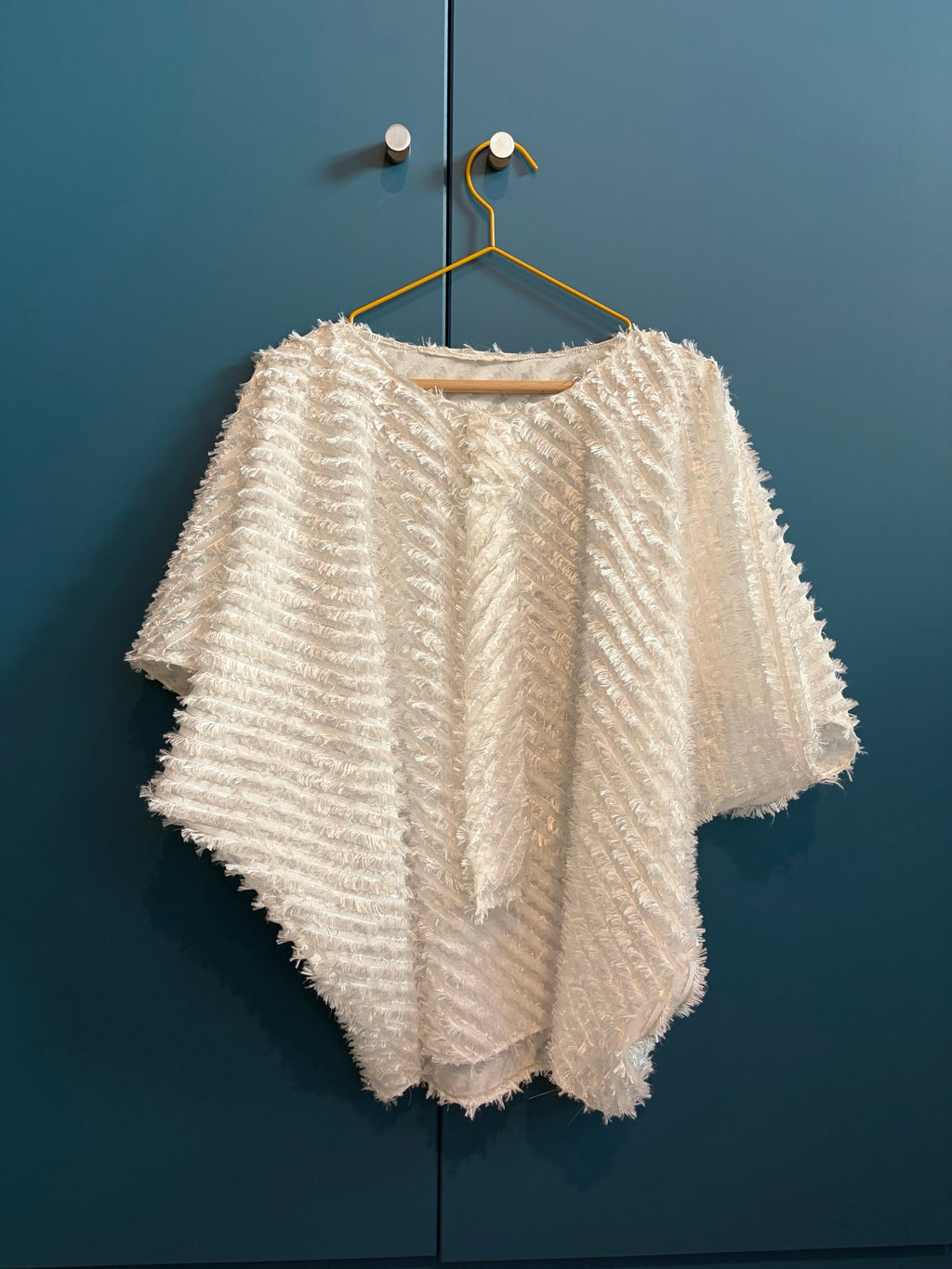 Light weighted feathery off-white top