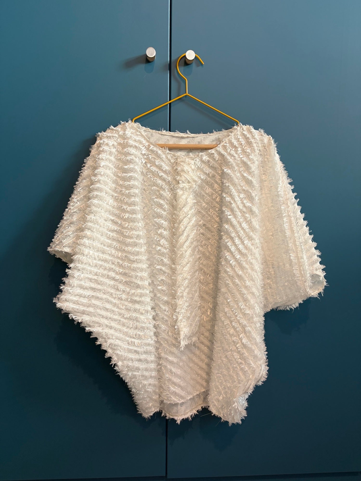 Light weighted feathery off-white top