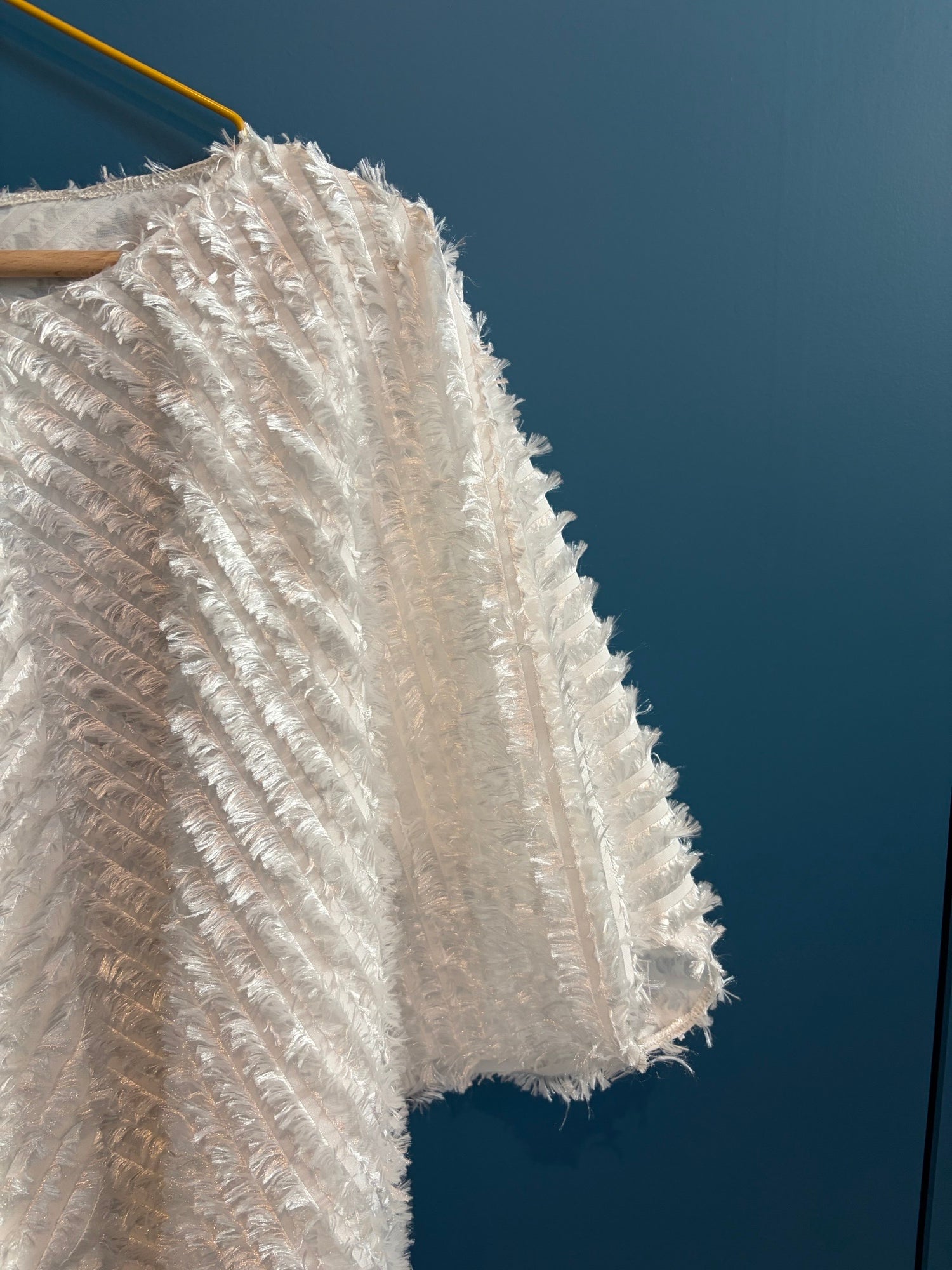 Light weighted feathery off-white top